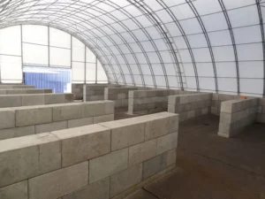 beton block inside round top tarp